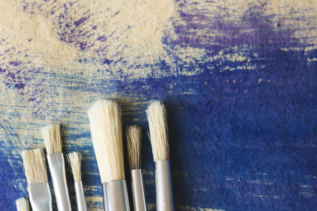 clean paintbrushes against painted paper