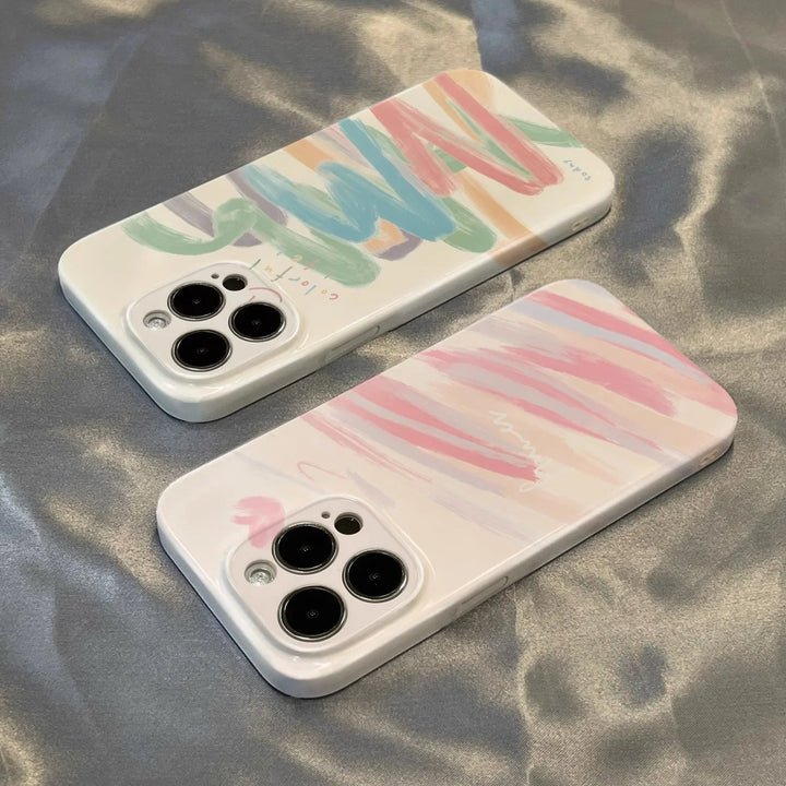 Two acrylic graffiti phone cases next to each other