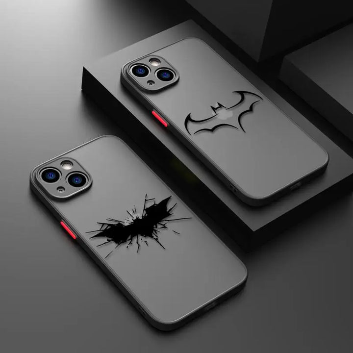 Two frosted phone cases featuring a Batman logo and a cracked Batman symbol