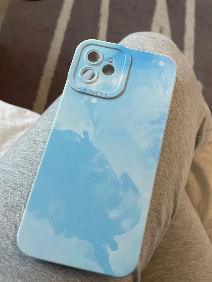 blue watercolor iphone case resting on leg