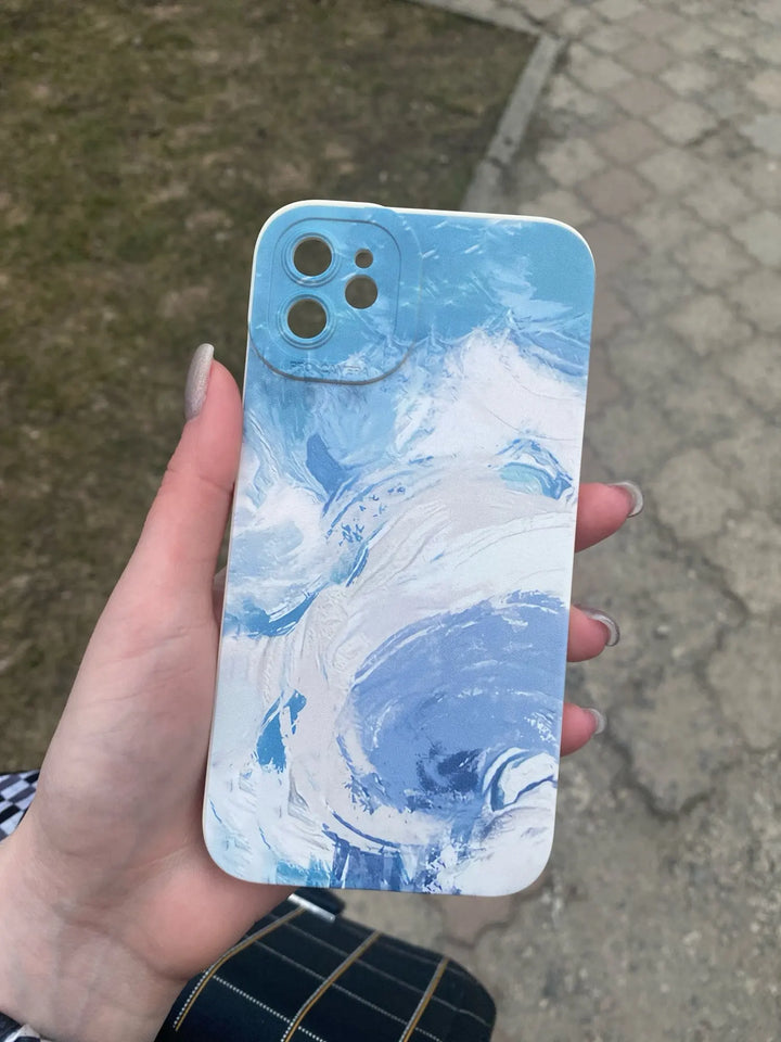 blue and white watercolor phone case in hand