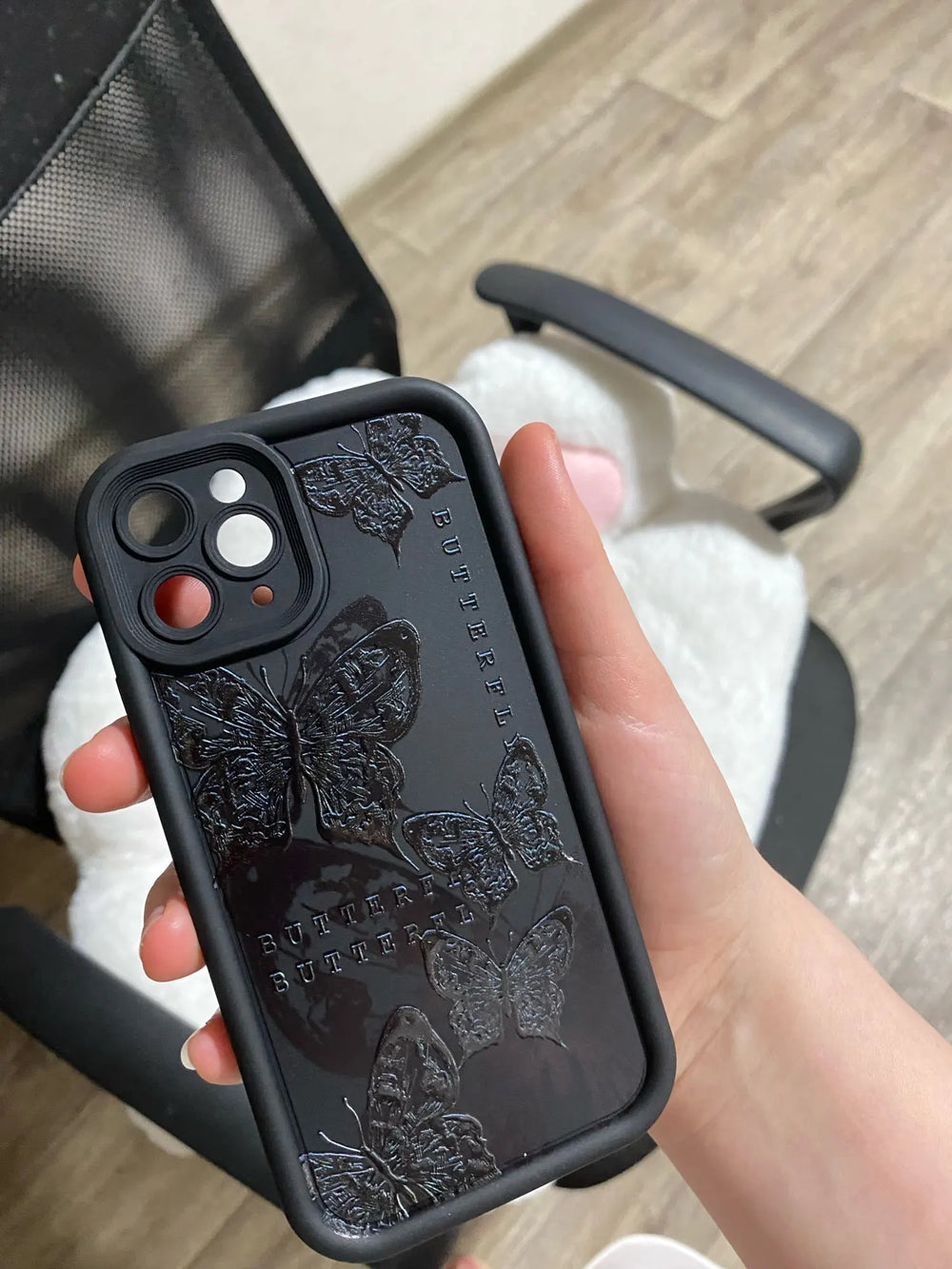 Photo of a black phone case with a butterfly desig