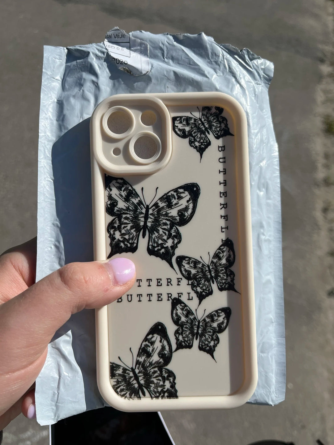 Photo of a white phone case with a butterfly desig