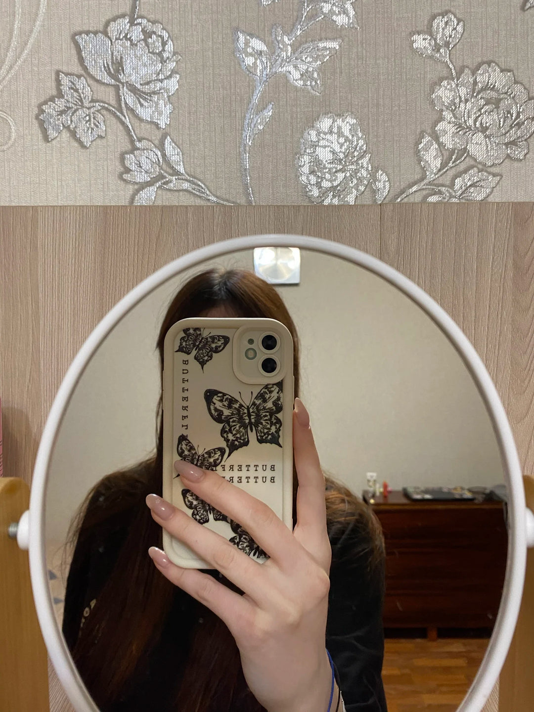 Photo of a white phone case with a butterfly design
