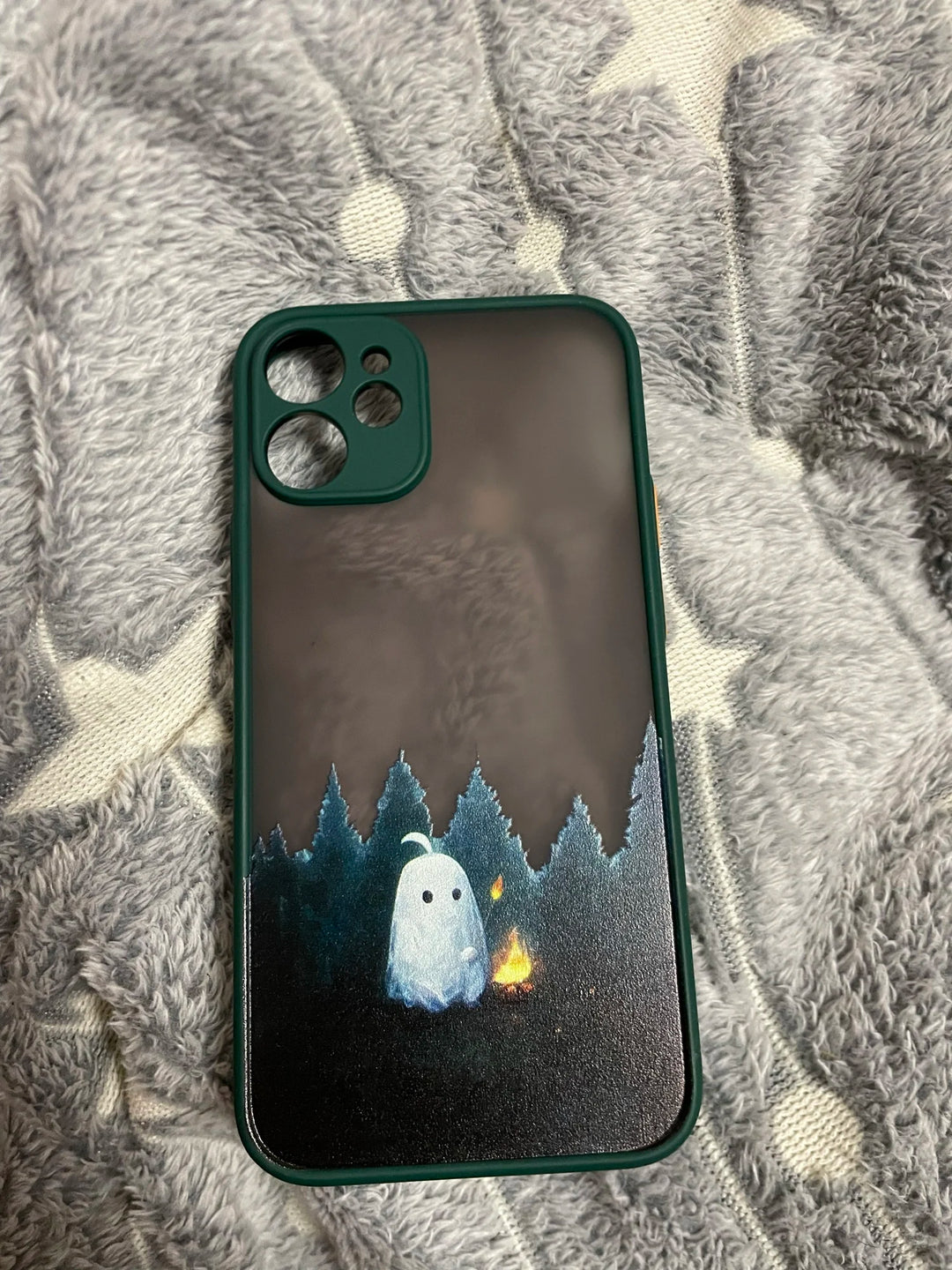 Phone case of cute ghost next to campfire