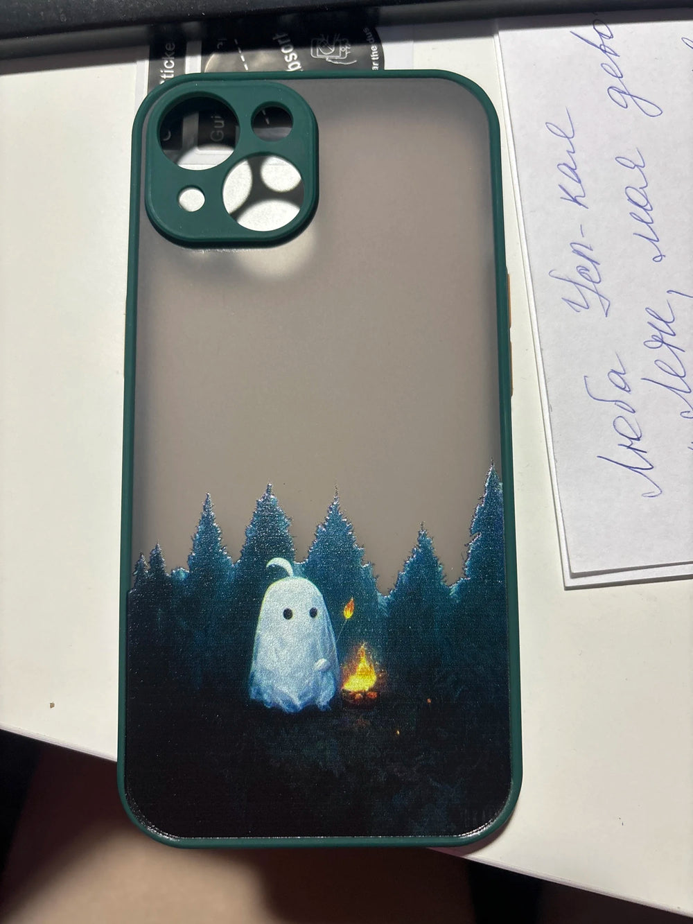 Phone case of cute ghost next to campfire