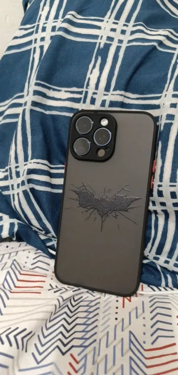 Phone case featuring a cracked Batman symbol