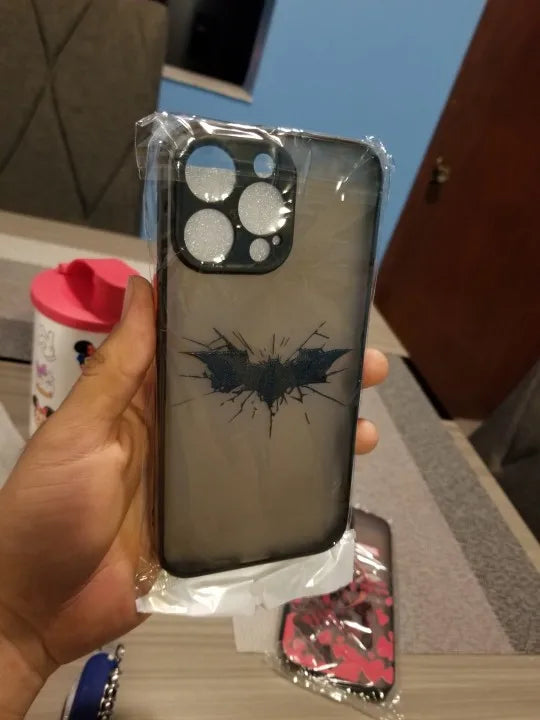 Phone case featuring a cracked Batman symbol