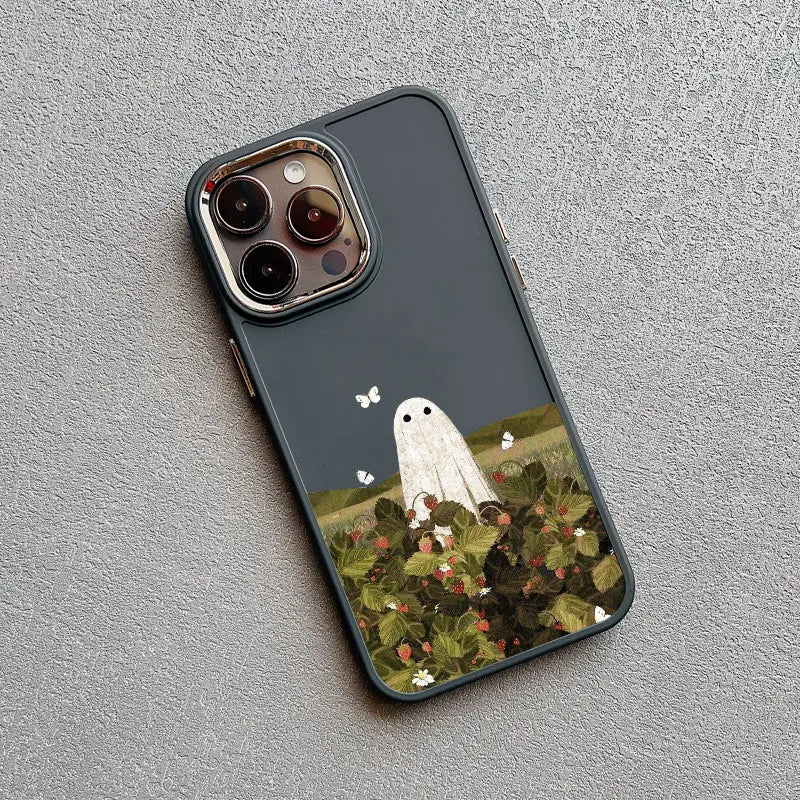 A dark gray phone case with a white ghost standing amidst a field of red strawberries.