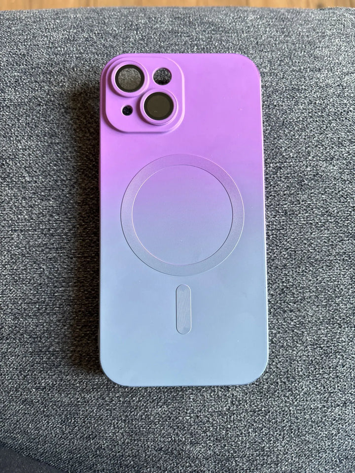 gradient phone case laying on gray sofa in background