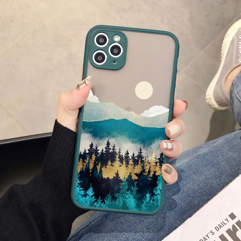 A green phone case with a frosted back showing a serene landscape with mountains, a forest, and a full moon