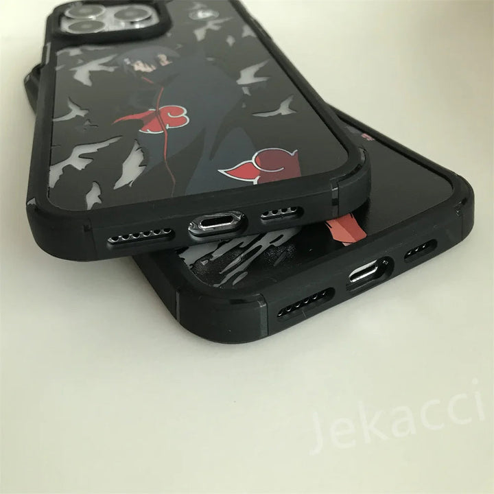 Two iPhones with black and red themed Hidden Leaf Legends cases are stacked on top of each other. The focus is on the bottom part, highlighting the charging ports and speaker grills, reminiscent of Naruto and Itachi's iconic aesthetic.