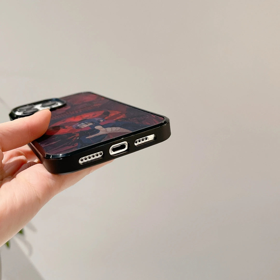 A hand holding a smartphone with an Itachi Angle Art case, showing the bottom view with the charging port and speakers, and compatible with MagSafe.