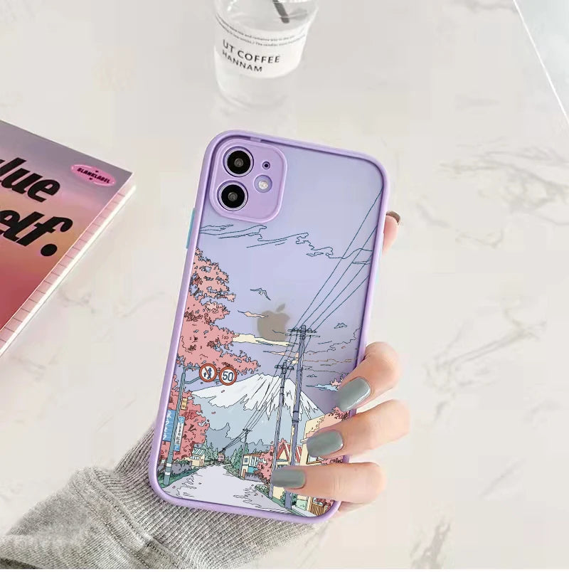 A frosted phone case with a cherry blossoms and mountain scene depicted on the back