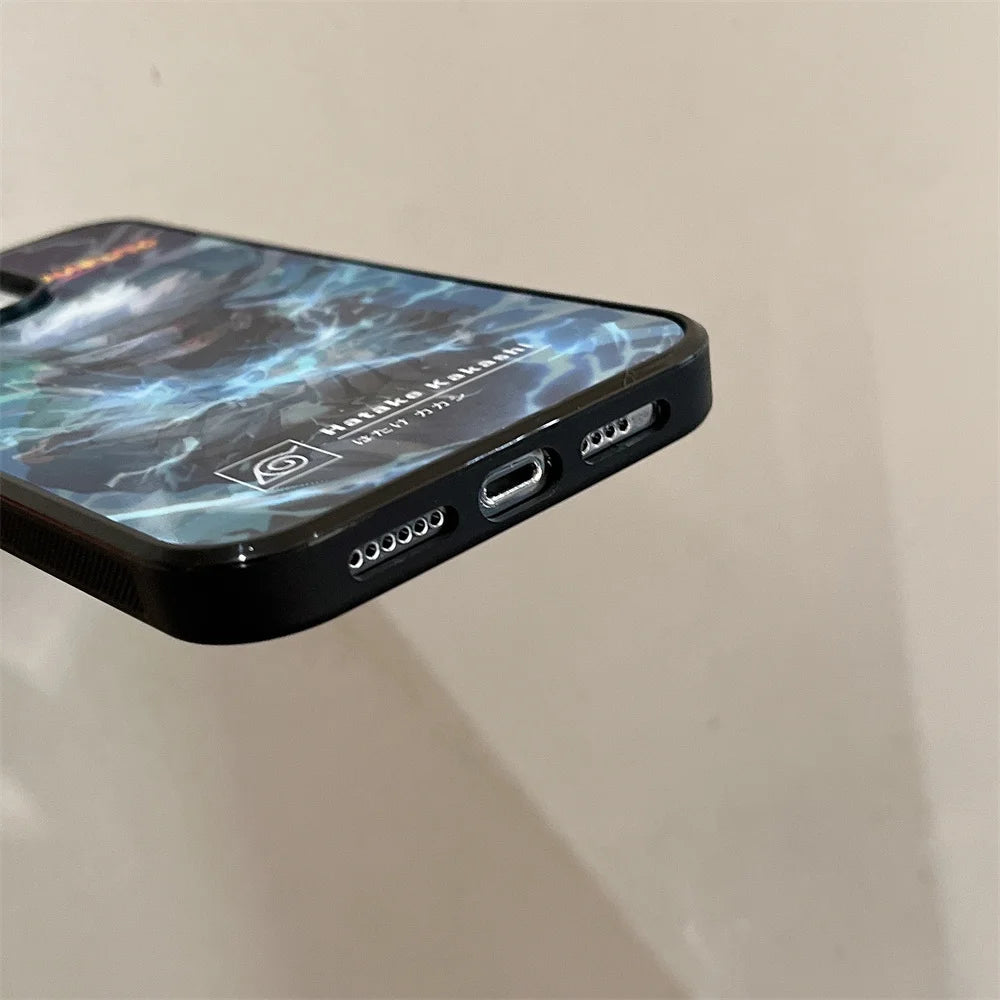 Close-up of a smartphone showing the bottom edge with a charging port, speaker holes, and a partially visible Kakashi Angle Art case on the back cover.