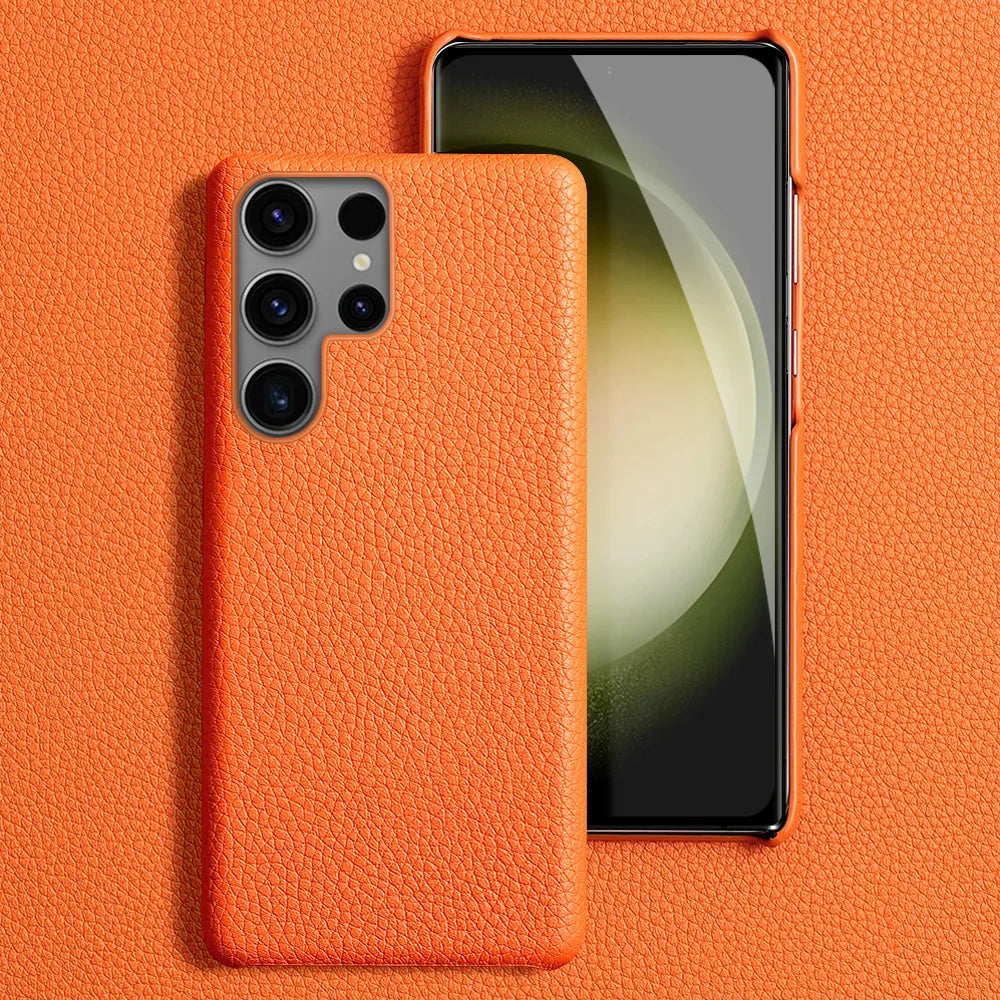 A Samsung smartphone featuring a Leather Phone Case For Samsung in orange cowhide leather, displaying both the rear camera lenses and the front display screen against an orange textured background that complements the leather phone case perfectly.