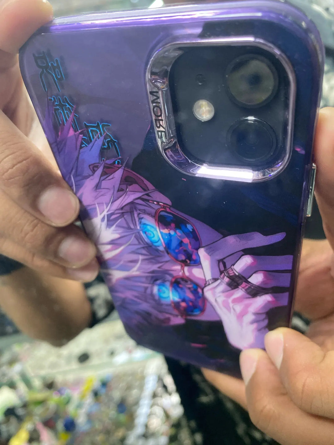 A phone case featuring Satoru Gojo from Jujutsu Kaisen, showcasing Gojo's intense expression and blue eyes known as the six eyes.