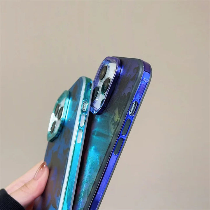 Two hands holding up smartphones with Mewtwo for iPhone cases featuring iridescent finishes, one adorned with a subtle Mew design. The phones' camera modules and side buttons are clearly showcased.