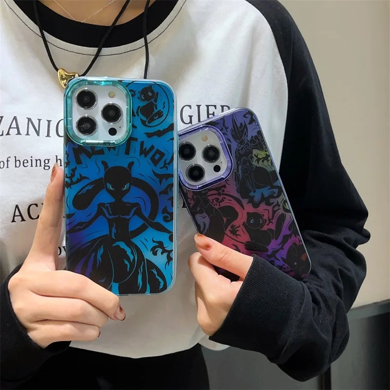 A person is holding two iPhones with patterned cases, each featuring dark, stylized character designs against contrasting blue and purple backgrounds. One phone case showcases the sleek figure of Mewtwo on the "Mewtwo for iPhone" case, while the other highlights the whimsical form of Mew.