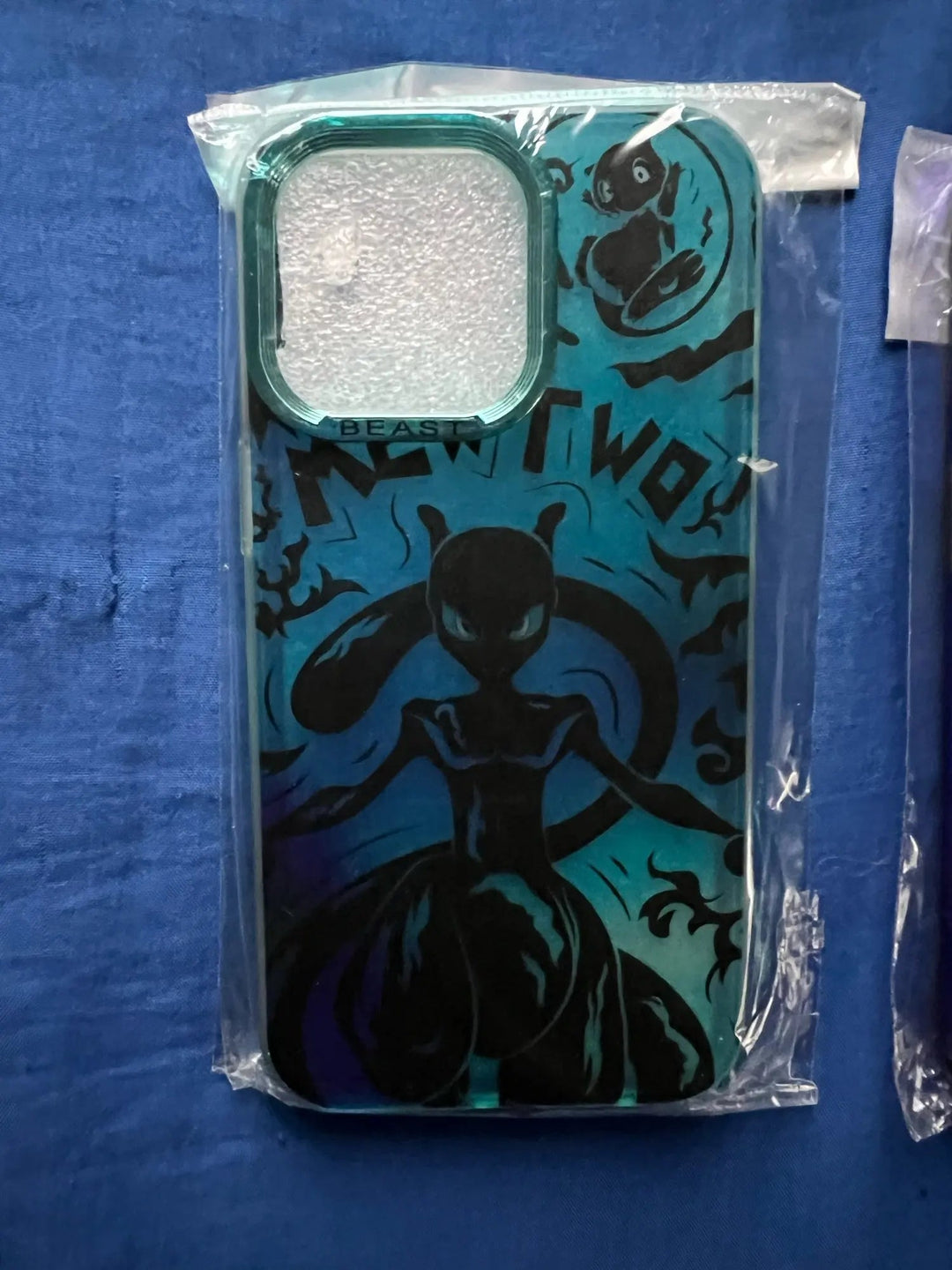 A blue and black "Mewtwo for iPhone" smartphone case featuring a stylized, animated Mewtwo design, packaged in a clear plastic sleeve.