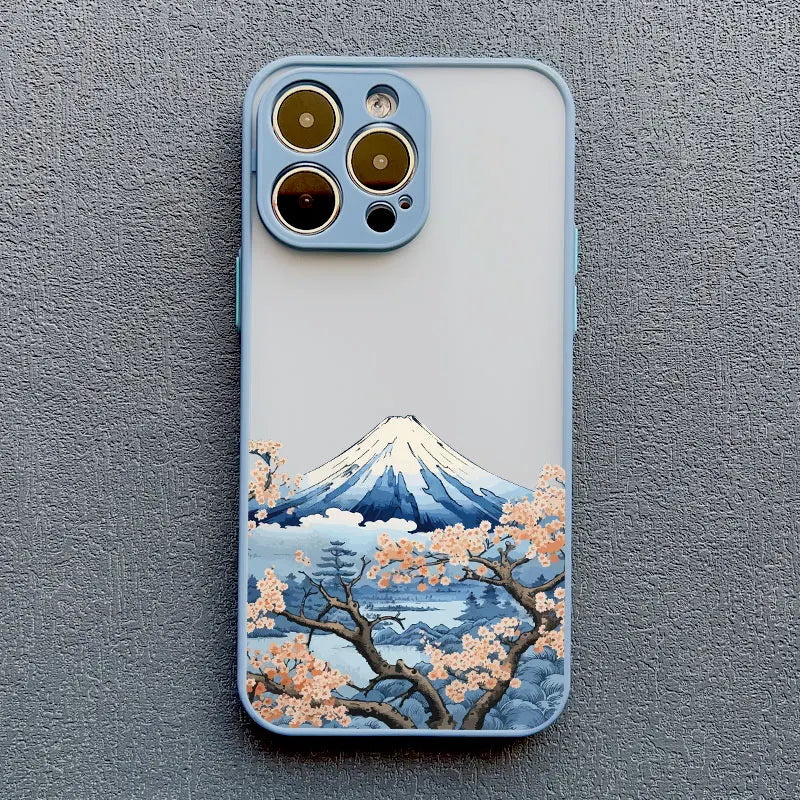 A blue phone case with a clear back featuring a Japanese landscape with Mount Fuji and orange cherry blossoms