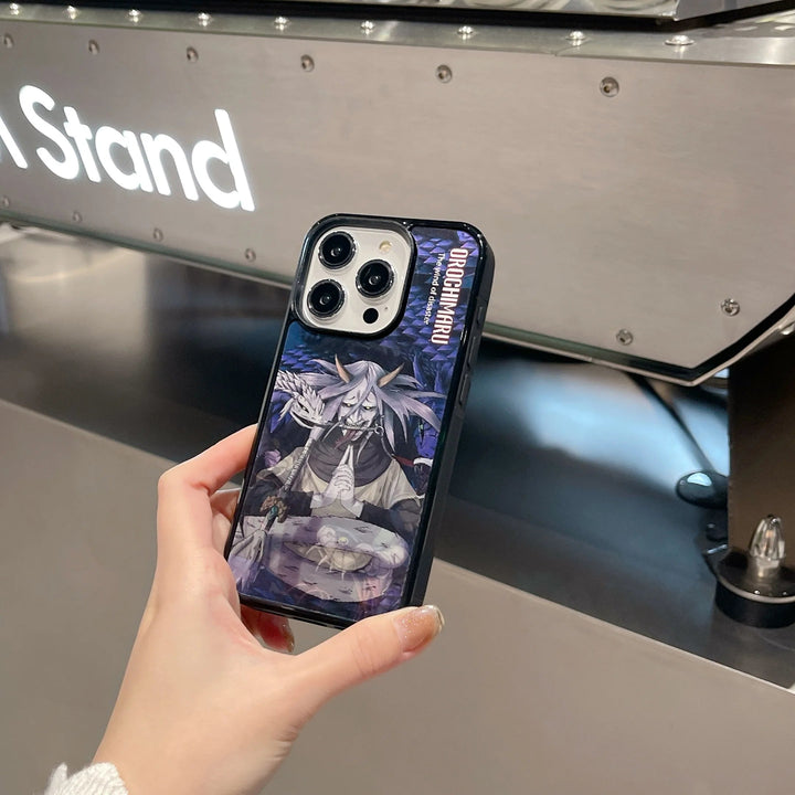 A hand holds a MagSafe compatible smartphone adorned with the Orochimaru Angle Art case, showcasing a striking animated character design against a metallic surface.