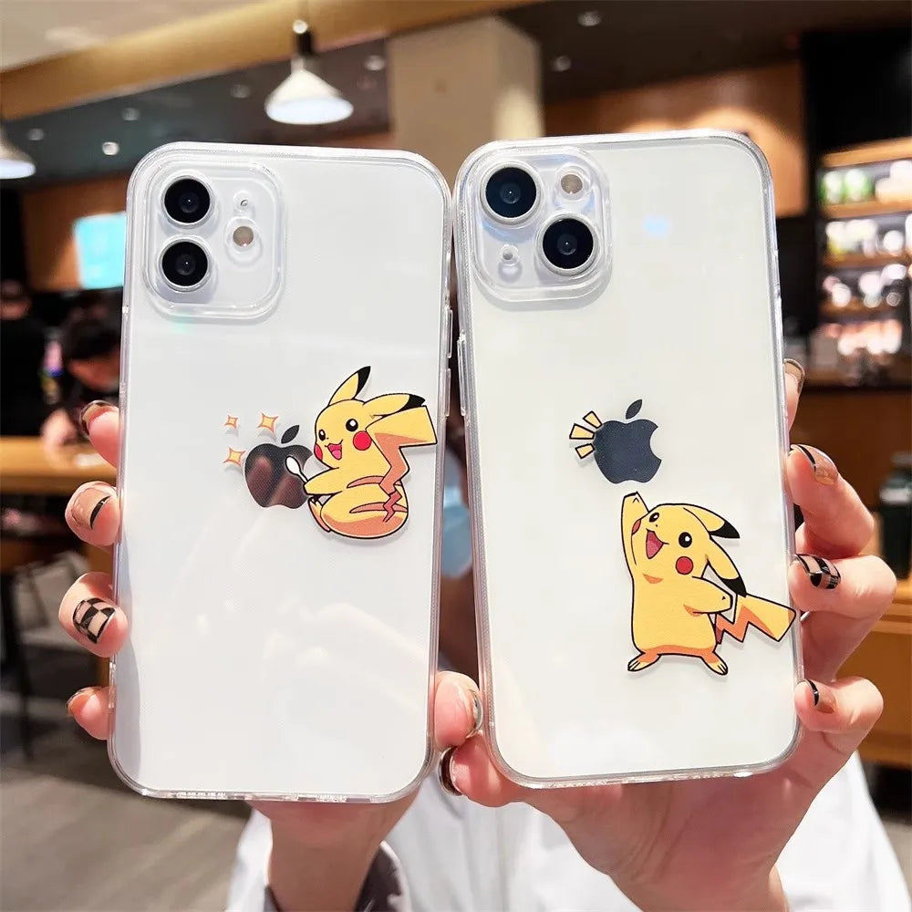 Two hands holding iPhones with Pikachu Clear Cases. One case depicts Pikachu hugging an apple, while the other shows Pikachu lifting an apple. The background appears to be a coffee shop, and both cases feature anti-scratch silicone with a playful Pikachu theme.