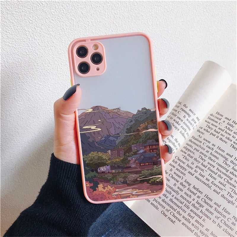 A pink phone case with a frosted back showing a serene landscape with mountains, a river, and a traditional Japanese-style building