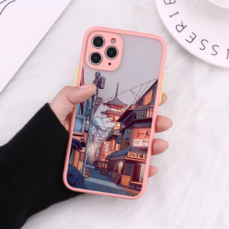 A pink phone case with a frosted back showing a bustling Japanese street scene at night