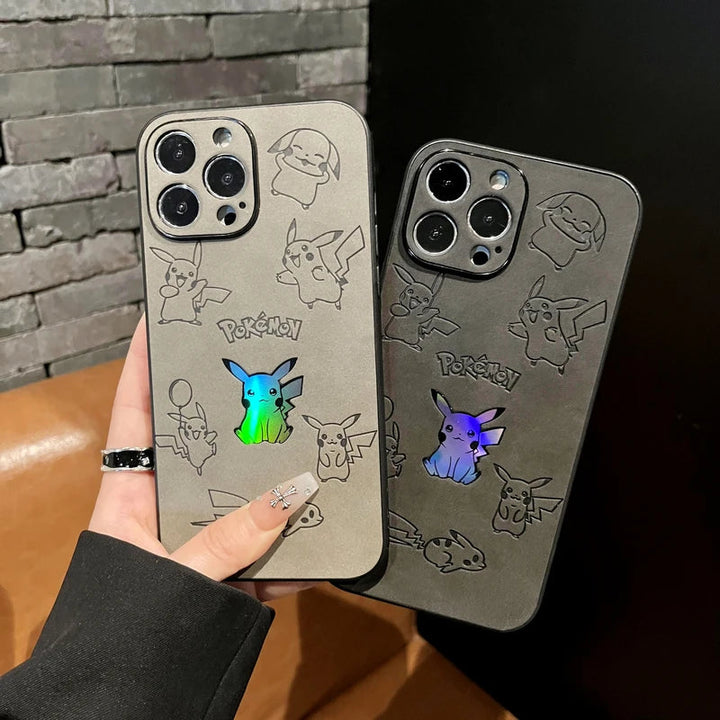 Two hands hold iPhones encased in Retro Pikachu silicone cases, showcasing retro-inspired Pokémon designs and holographic Pikachu illustrations. The background includes a brick wall and a brown sofa.