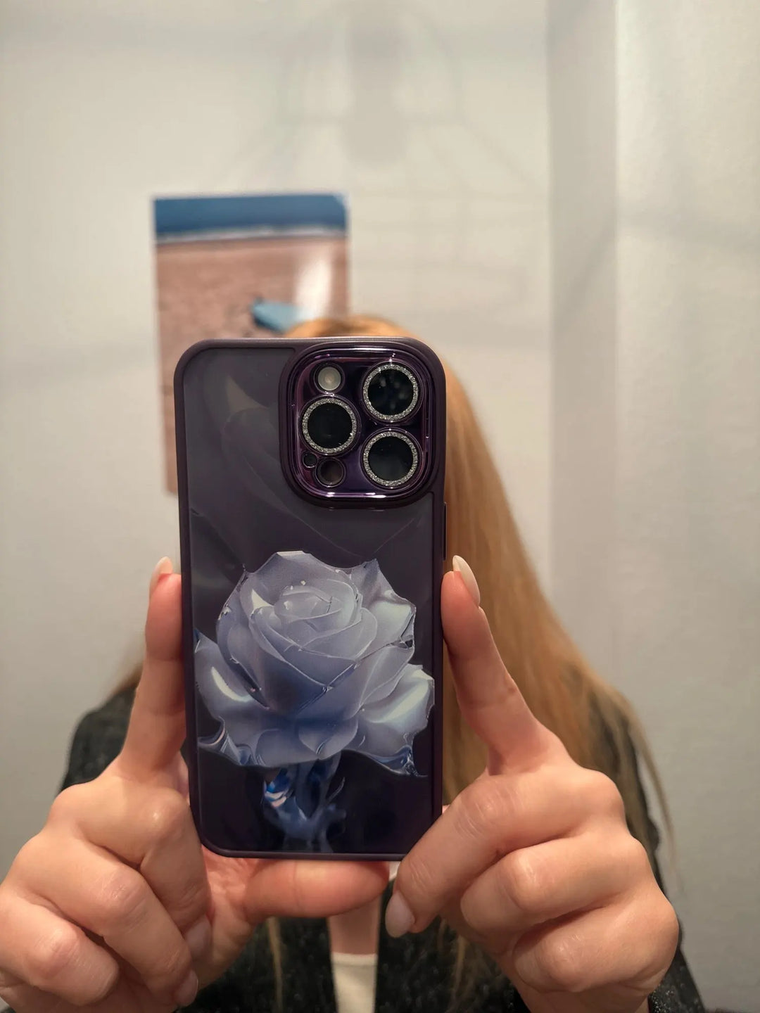 A phone case with a clear, transparent back featuring a vibrant rose design