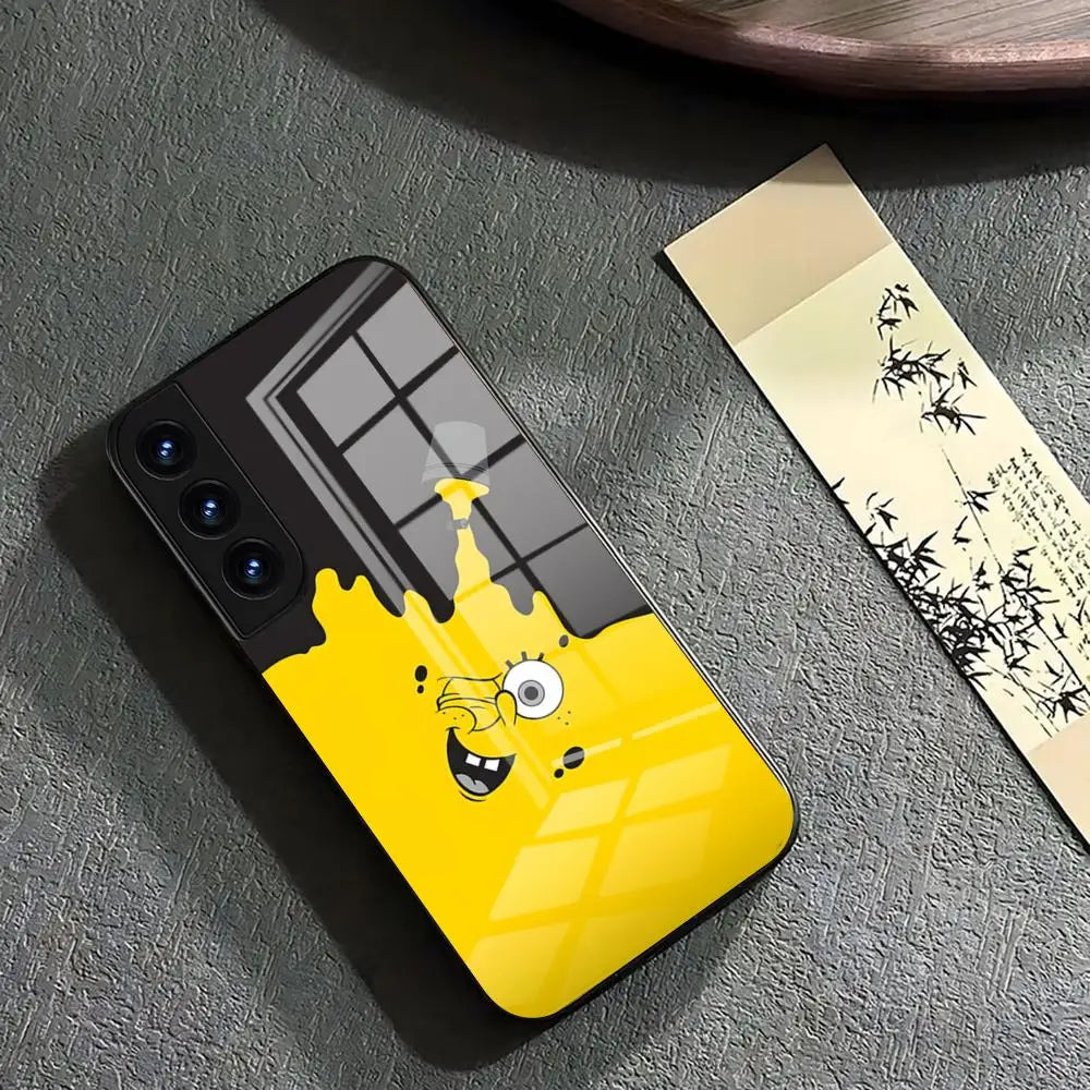 A glass phone case featuring a cartoon-style illustration of SpongeBob SquarePants' face