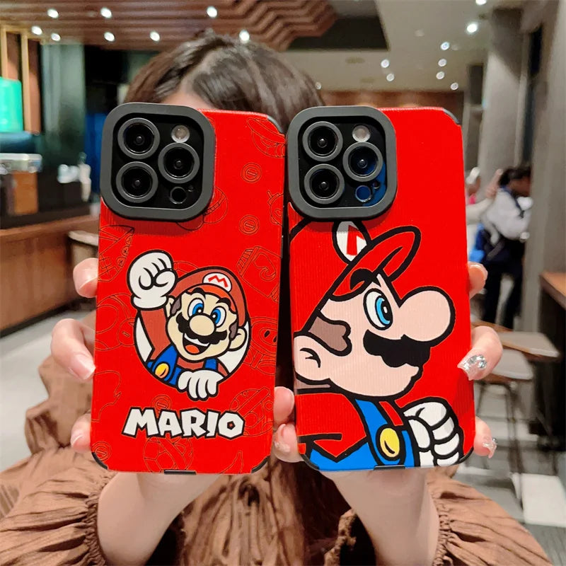 Two hands hold protective phone cases from the Super Mario for iPhone series. One hard plastic case showcases Mario’s face, while the other displays a side profile of Mario in his iconic red hat and blue overalls.