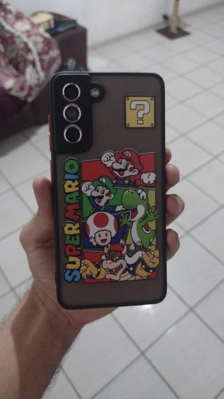 A person holds a lightweight Samsung smartphone with the Super Mario for Samsung case, featuring Mario, Luigi, Yoshi, Toad, and a question mark block. This anti-scratch case not only showcases your love for the franchise but also protects your device in style.