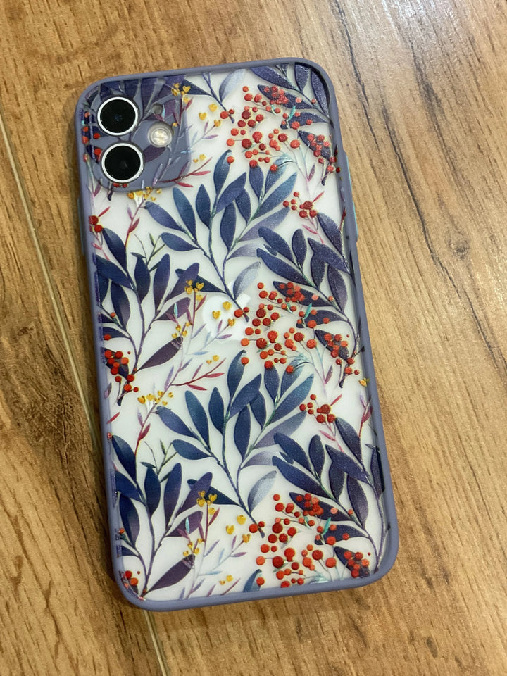 A photo of frosted phone case with a floral pattern. The case features blue leaves and red and yellow berries.