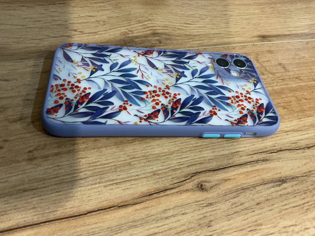 A photo of frosted phone case with a floral pattern. The case features blue leaves and red and yellow berries.