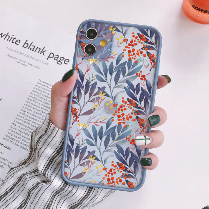 A photo of frosted phone case with a floral pattern. The case features blue leaves and red and yellow berries.