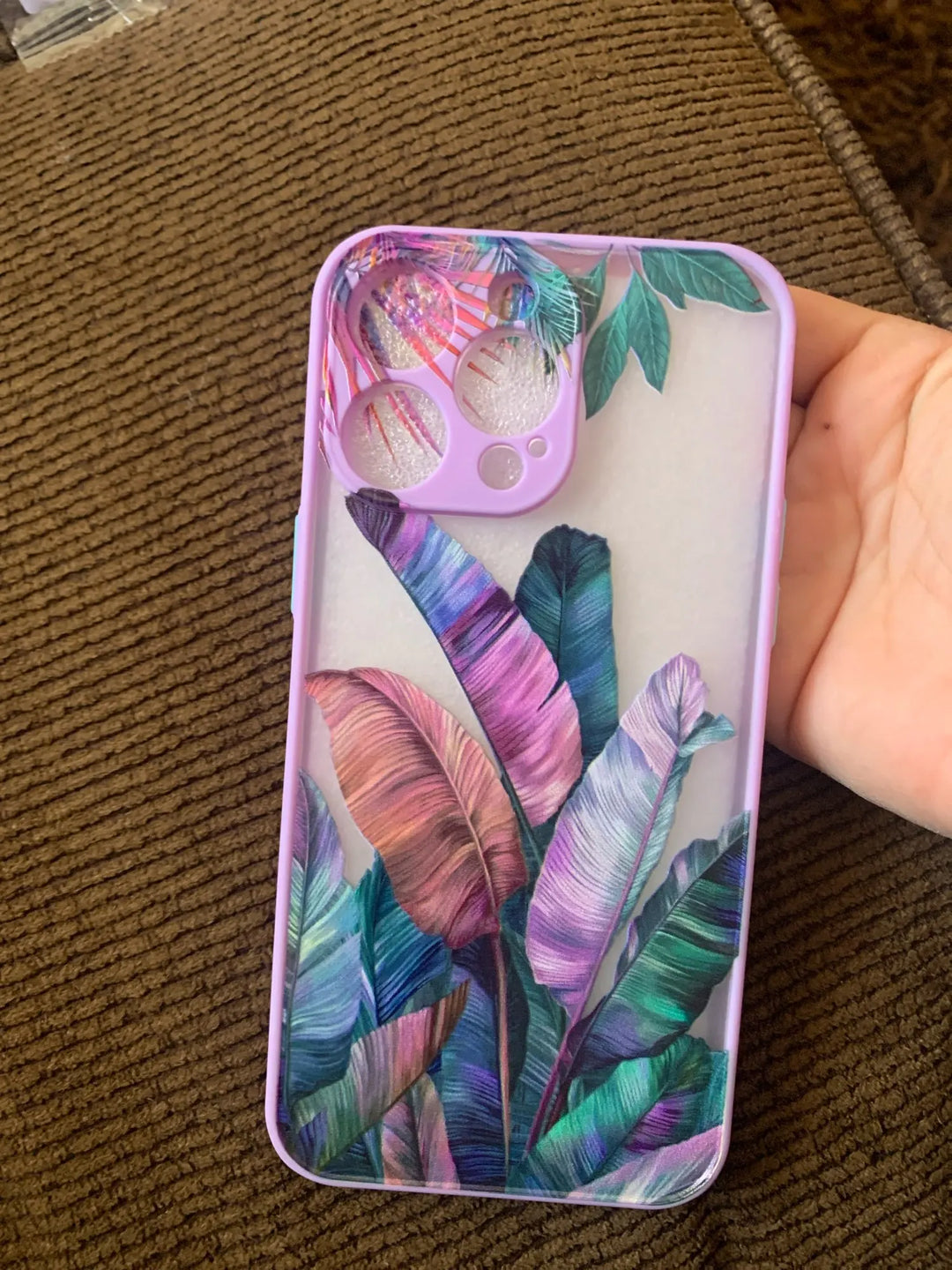 Photo of frosted phone case with a vibrant tropical leaf design