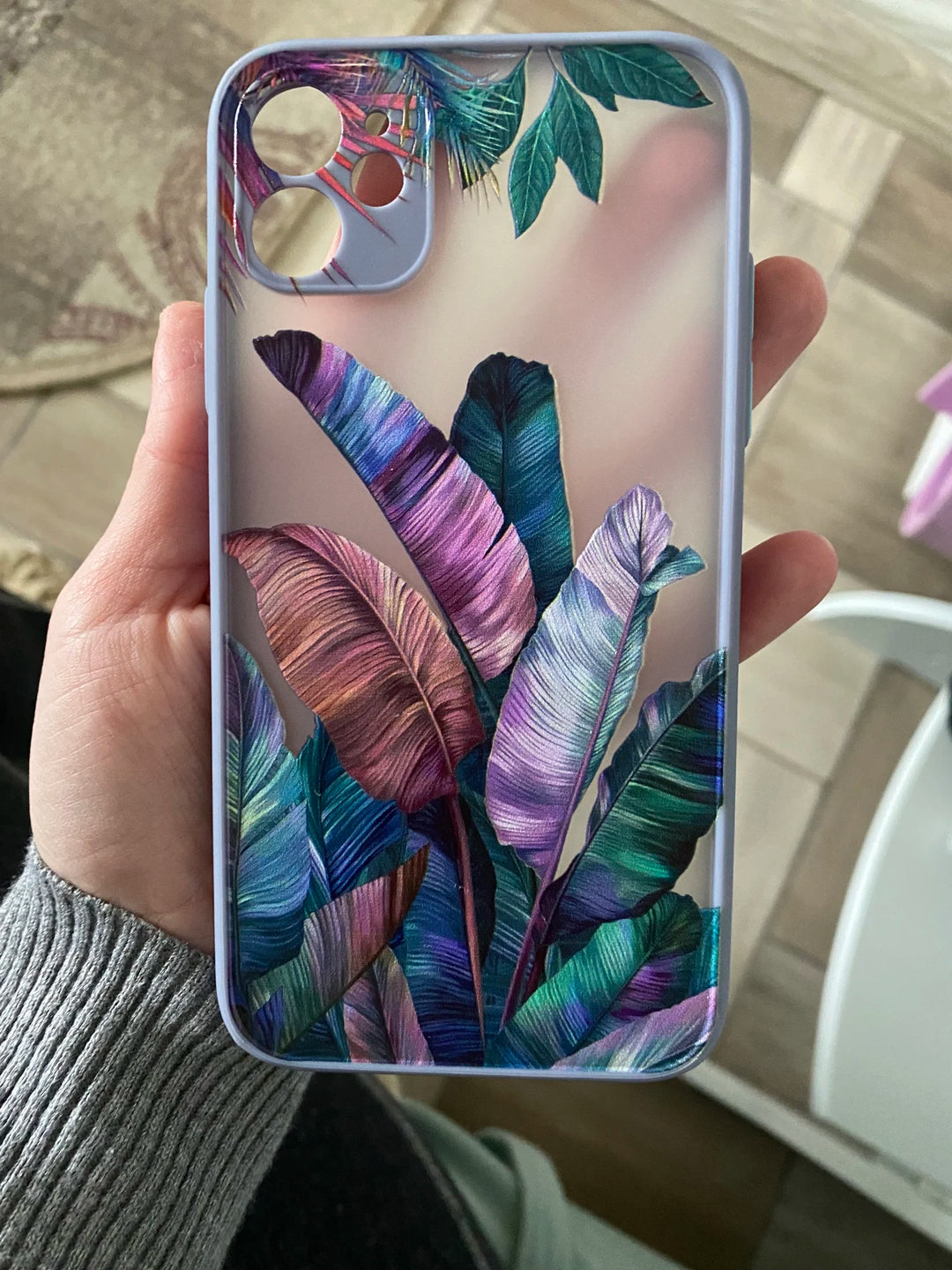 Photo of frosted phone case with a vibrant tropical leaf design