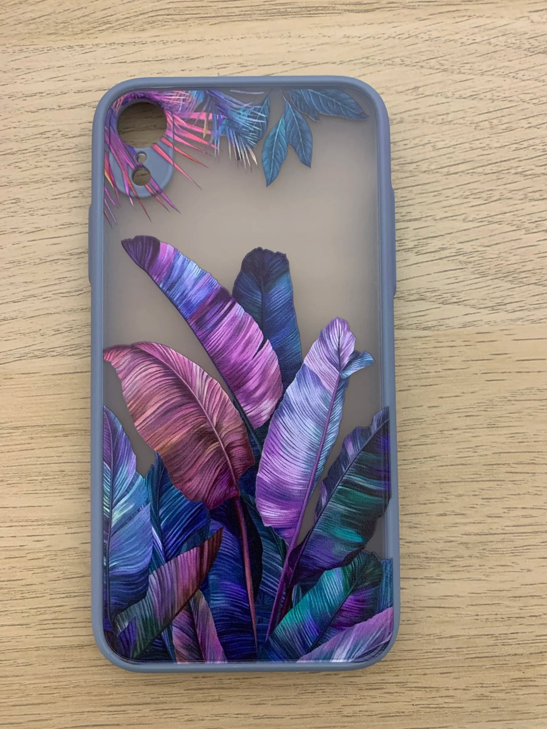 Photo of frosted phone case with a vibrant tropical leaf design