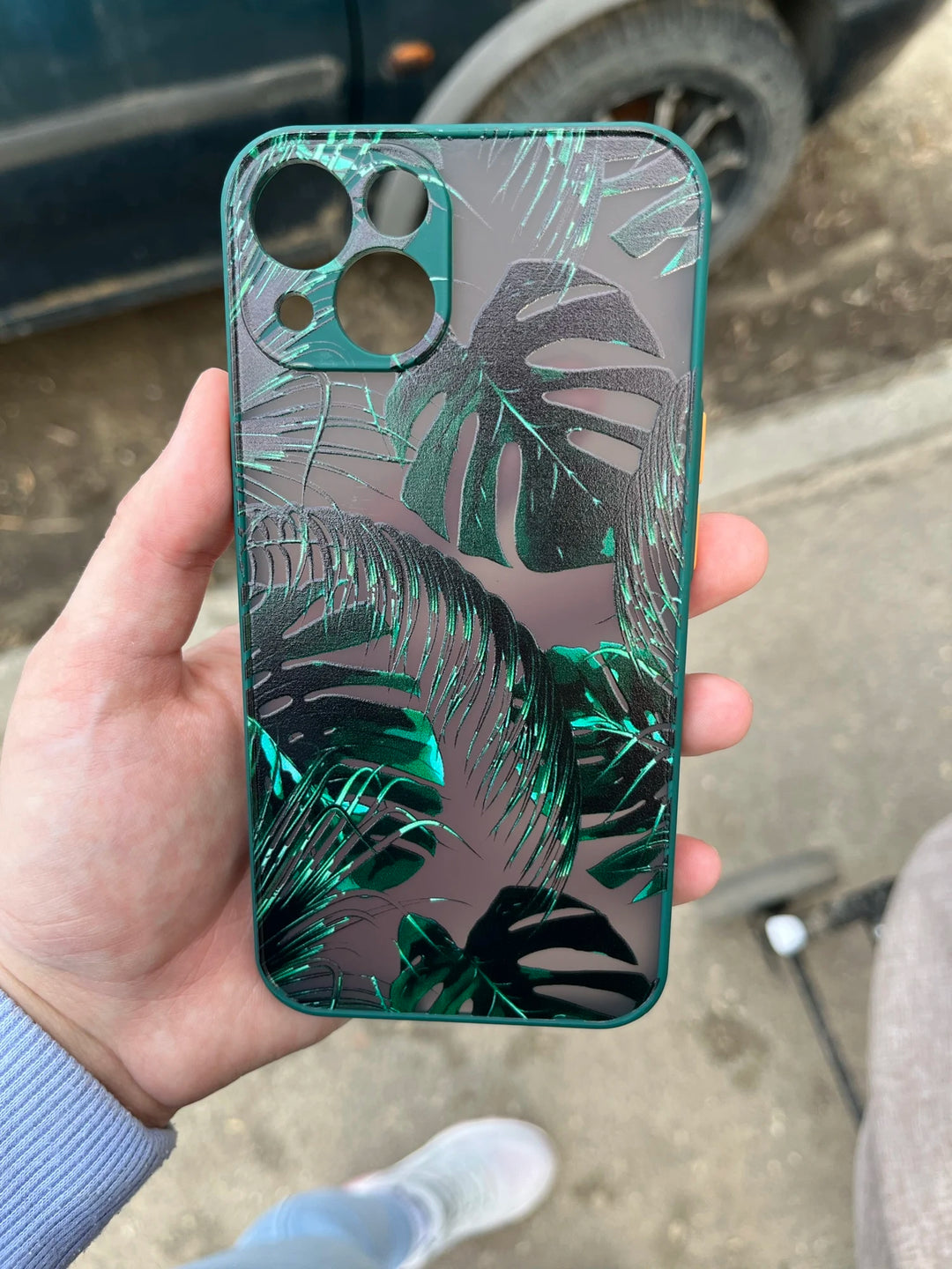 Photo of frosted phone case with a vibrant tropical leaf design