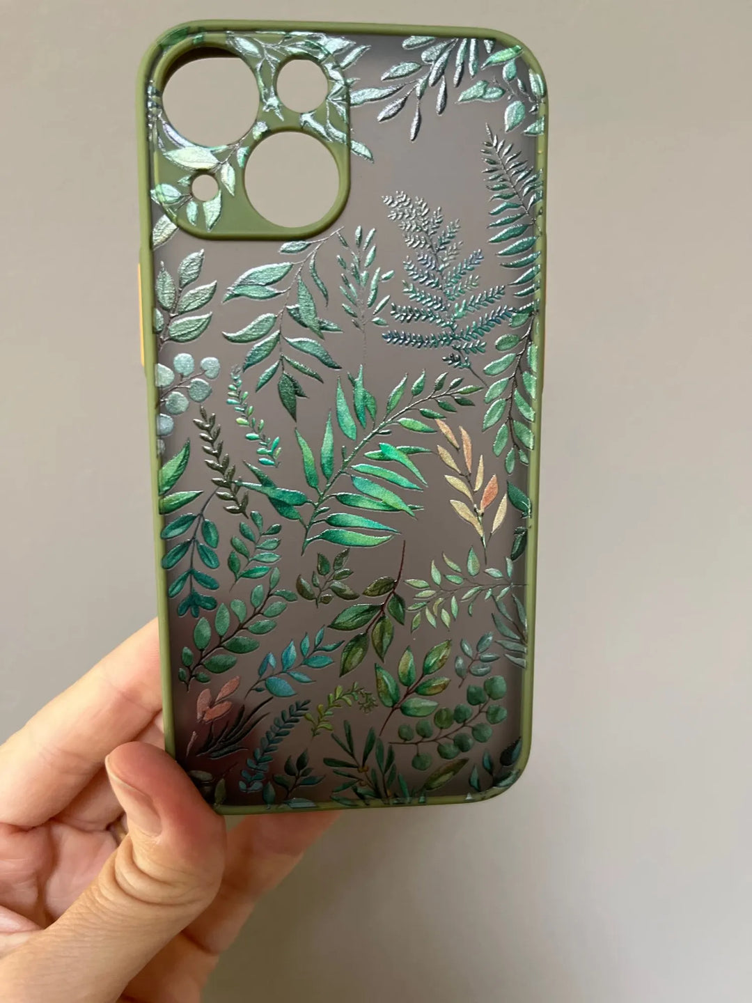 Photo of frosted phone case with a vibrant tropical leaf design