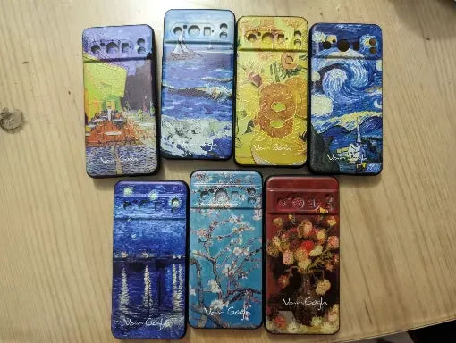 Collection of Van Gogh 3d cases for google pixel laid on table