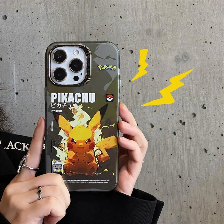 A person holds an iPhone with a Vibrant Plating Pokemon Case for iPhone, which boasts a Pikachu-themed, anti-scratch design and accompanying text. The grey concrete wall in the background is adorned with a yellow lightning bolt graphic, heightening the Pokémon flair in the scene.