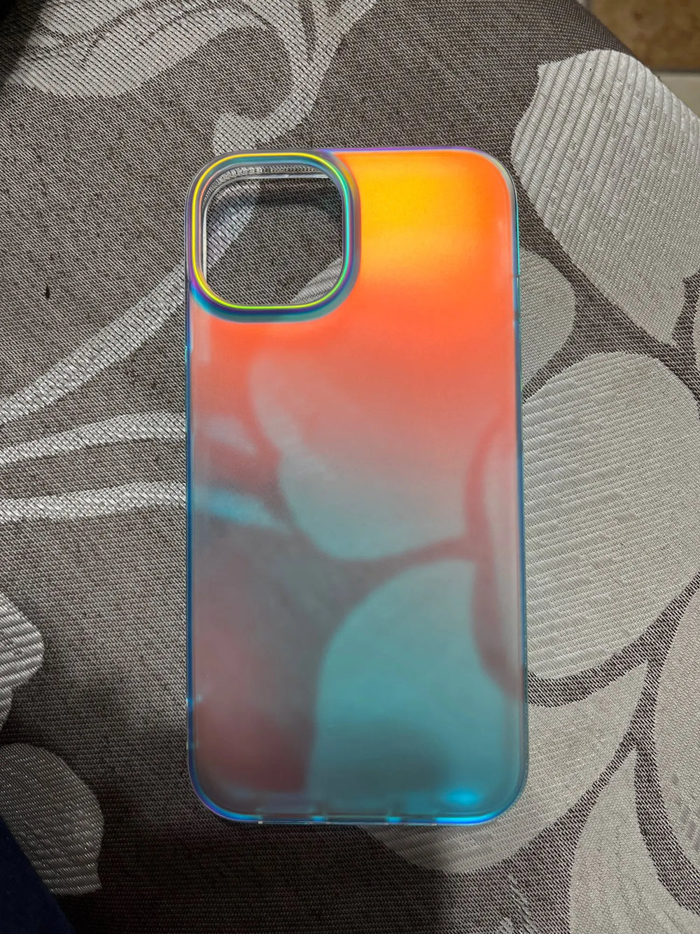 A gradient white phone case laying on fabric background